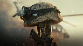 A promotional image from the Delta Force game showing a war helmet balancing on top of a vertical gun, a helicopter in the background.