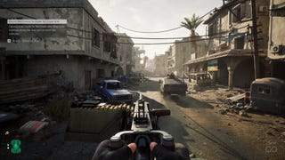 A screenshot of Delta Force, showing the player manning a heavy machinegun turret on the back of a Humvee as it drives down a detritus-filled Mogadishu street.